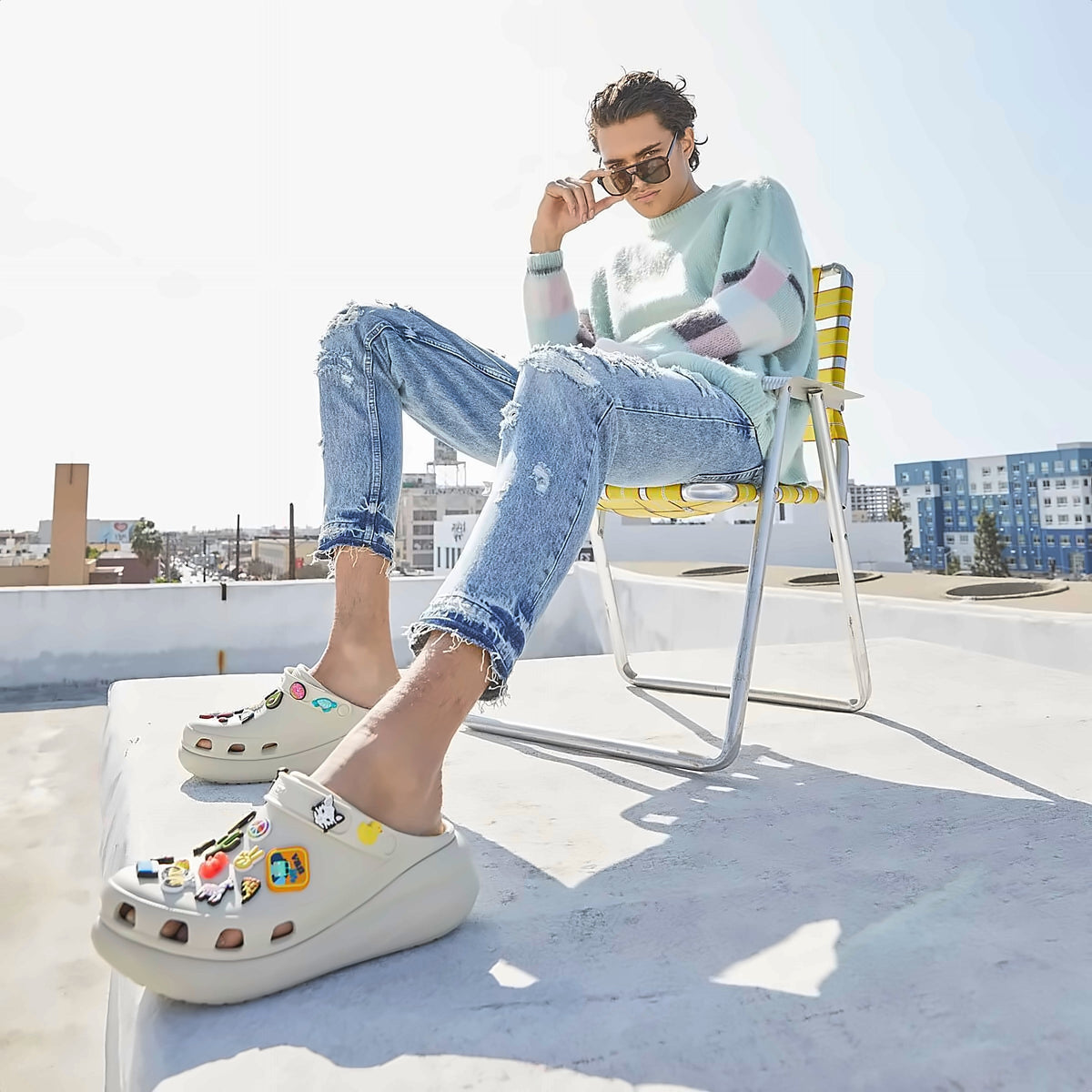 Clogs with charms worn on a sunny rooftop